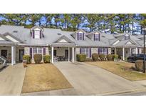 Charming townhome with a well-manicured lawn and a private driveway at 437 Colonial Trace Dr. # 2C, Longs, SC 29568