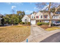 Charming two-story home with attached garage, well-manicured lawn, and mature landscaping at 46 Pembroke Ln. # 46, Pawleys Island, SC 29585