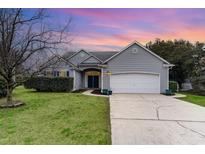 Charming single-story home with gray siding, manicured lawn, and attached two-car garage at 481 Morning Glory Ct., Myrtle Beach, SC 29579