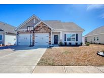 Charming single-Gathering home with a two-car garage and well-maintained front yard on a sunny day at 568 Canborough Lane, Murrells Inlet, SC 29576