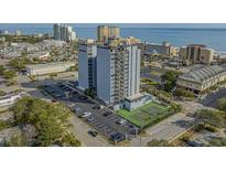 Aerial shot of condo building with a tennis court, parking lot, and close proximity to the beach at 601 Mitchell Dr. # 808, Myrtle Beach, SC 29577
