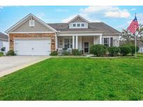 Charming single-story home featuring a well-manicured lawn and a welcoming front porch with decorative stone accents at 676 Lafayette Park Dr., Little River, SC 29566