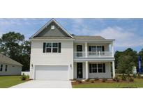 Charming two-story home boasts white siding, a balcony, and a well-manicured front lawn at 104 Fair Meadow Ct., Loris, SC 29569