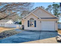 Charming single-Gathering home with a garage and well-manicured front lawn, perfect for suburban living at 105 Wagon Wheel Ln., Surfside Beach, SC 29575