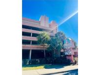 Exterior shot of Sandcastle Oceanfront Resort South with palm trees and sign on a sunny day at 2207 Ocean Blvd. S # 1217, Myrtle Beach, SC 29577