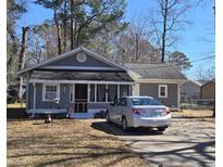 Charming single-story home featuring a gray exterior, well-kept yard, and a driveway with parking at 330 Fairwood Terrace, Myrtle Beach, SC 29588