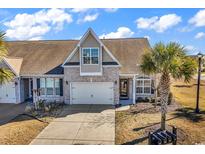 Charming home with a well-manicured lawn, tan brick, and an attached two-car garage at 5027 Prato Loop, Myrtle Beach, SC 29579