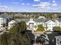 Exterior full view of condo with an adjacent parking lot and mature trees at 601 Hillside Dr. N # 3736, North Myrtle Beach, SC 29582