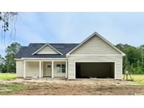 Charming single-story home with a covered porch, garage and light siding at 6049 Hodges Rd., Conway, SC 29527