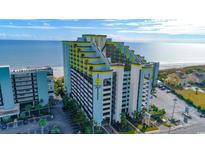 Stunning exterior view of a high-rise resort with ocean views and manicured landscaping, offering a luxurious coastal lifestyle at 6804 N Ocean Blvd. # 1211, Myrtle Beach, SC 29572