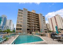 Exterior shot featuring a pool and seating area in front of an eight-story building at 7601 N Ocean Blvd. # 4-D, Myrtle Beach, SC 29572