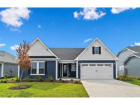 Charming single-Gathering home featuring blue siding, white trim, and a well-manicured lawn at 763 St. Vincent Loop, Little River, SC 29566