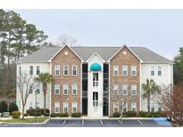 Attractive condo building featuring stone and siding exterior accents and neatly kept landscaping at 9768 Leyland Dr. # 7, Myrtle Beach, SC 29572