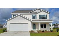 Charming two-story home featuring a two-car garage, teal door, and landscaped yard at 1005 Garden Sprout Dr, Galivants Ferry, SC 29544