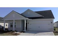 Charming single-story home featuring a two-car garage and covered porch, enhanced by stylish brick accents and modern design at 2032 Copper Creek Loop, Longs, SC 29568