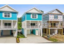 Beautiful blue and white raised beach home with large driveway and covered parking at 2306 Seaseeker Ln., Myrtle Beach, SC 29577