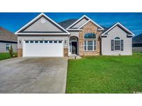 Charming one-story home with a well-maintained lawn, a two car garage, and a combination brick and siding facade at 269 Leste Rd., Myrtle Beach, SC 29588