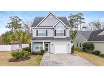 Charming two-story home with landscaped front yard, driveway, and a one-car garage at 313 Foxpath Loop, Myrtle Beach, SC 29588