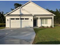 Charming single-story home with a white exterior, attached garage, and well-maintained lawn at 3186 Wayside Rd., Conway, SC 29527
