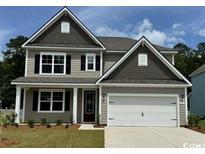 Charming two-story home featuring a two-car garage and well-manicured lawn at 543 Slaty Dr., Myrtle Beach, SC 29588