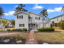 Charming exterior of home featuring a landscaped yard and inviting entryway with classic design elements at 609 23Rd Ave. N, North Myrtle Beach, SC 29582