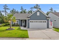 Charming single-story home featuring a well-manicured lawn, two-car garage, and a welcoming front porch at 1118 Prescott Circle, Myrtle Beach, SC 29577