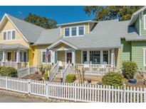 Charming two-story home with a white picket fence and welcoming front porch at 136 B Da Gullah Way # B, Pawleys Island, SC 29585