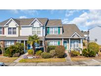 Charming townhome with a well-maintained front yard featuring lush landscaping and a cozy entrance at 1450 Portrait Circle # 1450, Myrtle Beach, SC 29577