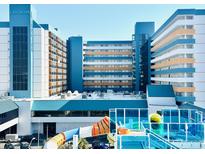 Bright and cheerful resort with a colorful waterslide and blue-accented architecture against a clear sky at 1501 S Ocean Blvd. # 841, Myrtle Beach, SC 29577