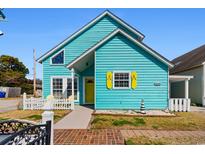 Charming beach house with bright blue siding, yellow shutters, and a welcoming front porch at 1607 Havens Dr., North Myrtle Beach, SC 29582