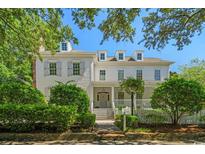 Charming white two-story home with gray shutters and a welcoming front porch surrounded by manicured landscaping at 201 Broad St., Georgetown, SC 29440