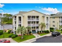 Inviting condo complex with a beautiful lawn, mature trees, and convenient parking at 218 Landing Rd. # G, North Myrtle Beach, SC 29582