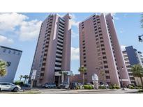 Two modern high-rise towers with multiple windows are surrounded by palm trees and parked cars at 2500 North Ocean Blvd. # 804, Myrtle Beach, SC 29577