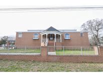 A brick house with a unique gazebo entrance and well-kept lawn at 300 19Th Ave. S, Myrtle Beach, SC 29577