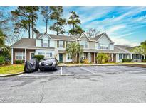 Charming townhomes with ample parking, brick accents, and mature trees, offering a welcoming curb appeal at 3506 Evergreen Way # 3506, Myrtle Beach, SC 29577