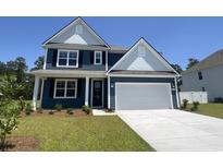 Charming two-story home with blue siding, white trim, and a convenient two-car garage at 358 Glacier Way, Conway, SC 29526