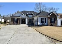 Charming single-story home boasts a well-manicured lawn, brick and vinyl siding, and a spacious driveway at 517 Brooksher Dr., Myrtle Beach, SC 29588