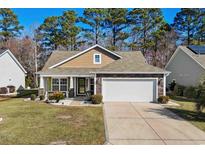 Charming single story home with a stone and shake exterior, a well-manicured lawn, and an attached two car garage at 725 Old Castle Loop, Myrtle Beach, SC 29579