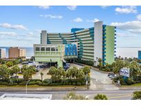 Lovely exterior of the Coral Beach Resort with lush landscaping and ample parking at 1105 S Ocean Blvd. # 1004, Myrtle Beach, SC 29577