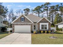 Charming single-story home with stone accents, manicured lawn, and an attached two-car garage at 1108 Inlet View Dr., North Myrtle Beach, SC 29582