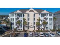 Three story condo building with exterior staircases, ample parking, and landscaped areas at 117 Ella Kinley Circle # 201, Myrtle Beach, SC 29588