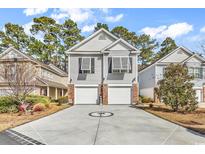 Charming two-story home features a spacious driveway and attached two-car garage at 1424 Powhaton Dr., Myrtle Beach, SC 29577