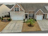 Charming home with well-manicured lawn, attached garage, and stone accents on the facade at 179-A Parmelee Dr. # A, Murrells Inlet, SC 29576