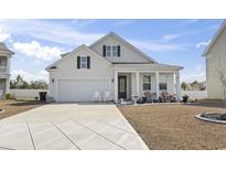 Charming single-Gathering home featuring a well-manicured front yard and a two-car attached garage at 360 Cattle Drive Circle, Myrtle Beach, SC 29588