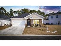 Charming single-story home with a well-manicured lawn, neutral siding and a cozy front porch at 4092 Bayhill St., Myrtle Beach, SC 29579