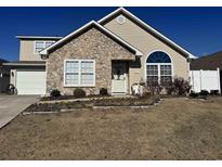 Charming home featuring stone accents, well-maintained landscaping, and a welcoming front entrance at 4305 Rivergate Ln., Little River, SC 29566