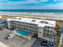 Aerial view of the King's View Villas complex, showcasing the pool, parking area and ocean view at 4406 N Ocean Blvd. # B-2, North Myrtle Beach, SC 29582