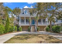 Charming coastal home with double garages, a basketball hoop, and inviting front porch at 534 South Creekside Dr., Murrells Inlet, SC 29576