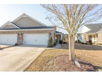 Charming home with attached garage and well-maintained lawn, creating inviting curb appeal at 537 Botany Loop # 537, Murrells Inlet, SC 29576