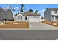 Charming single-story home with a two-car garage and well-maintained front yard at 591 Meadowgrass Ct., Myrtle Beach, SC 29588